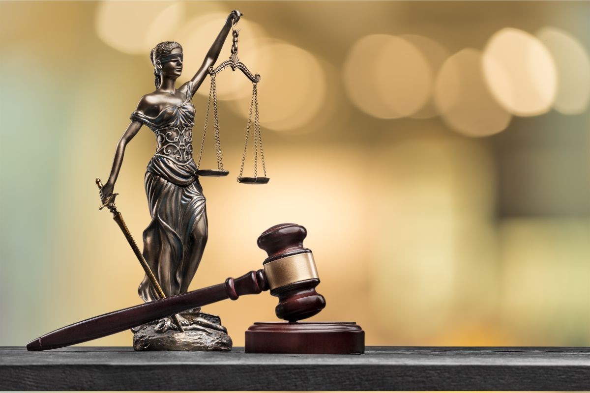 A picture of a lady justice statue and a gavel - if you are in need of a burglary attorney Palm Beach County, FL, contact Peterford Law today!