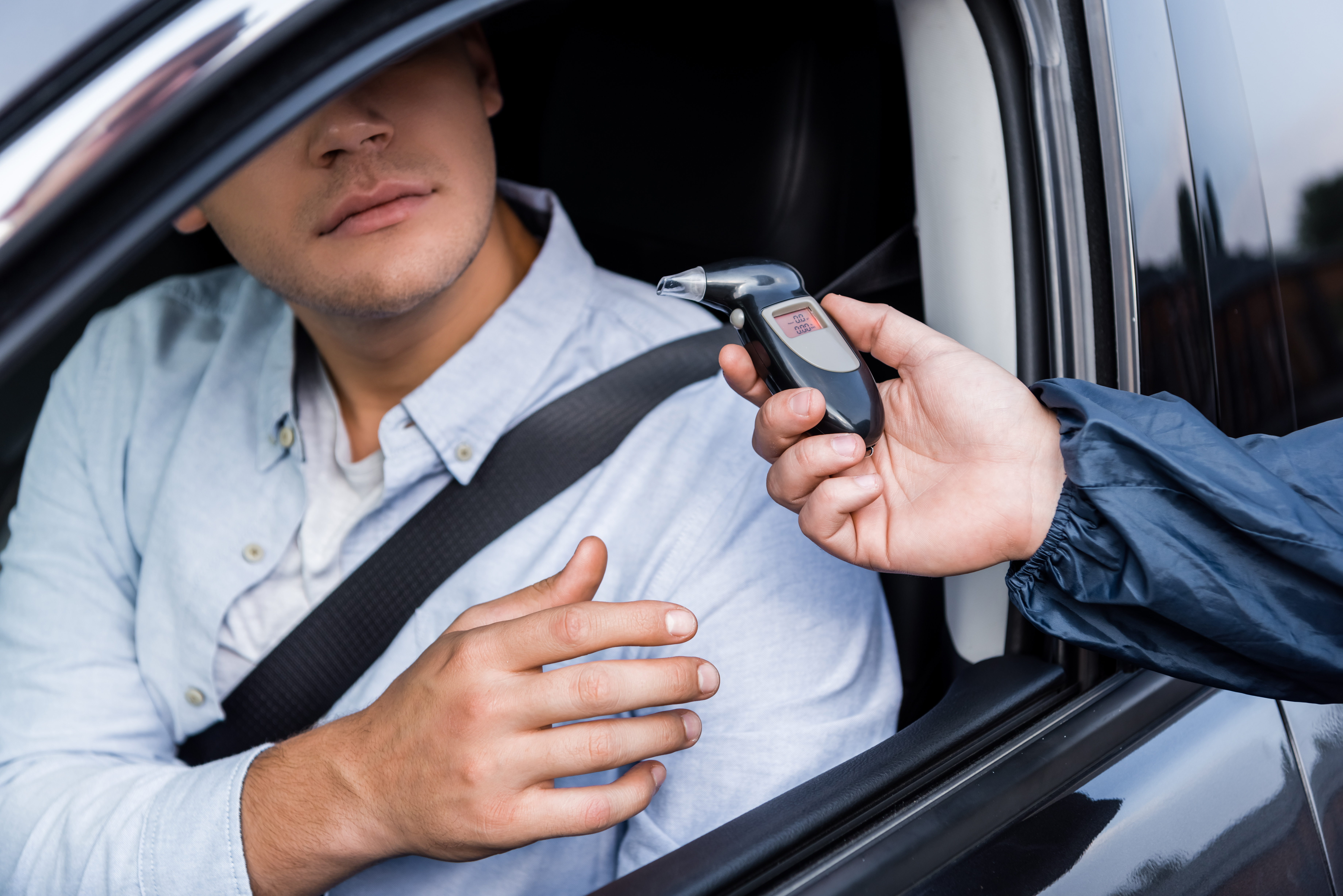A picture of a person being pulled over with breathalyzer test - Peterford Law can help you protect your rights!